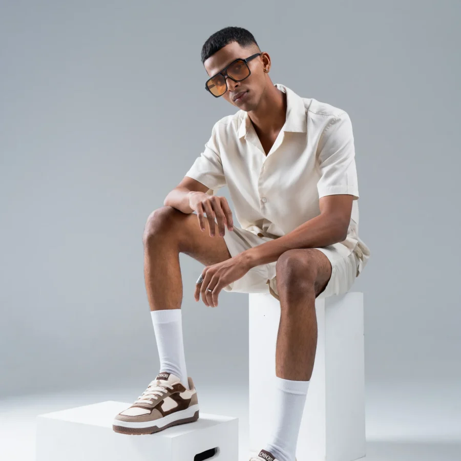 Man wearing Affogato CHNKS brown sneakers with off-white shirt and shorts – minimalist men’s streetwear