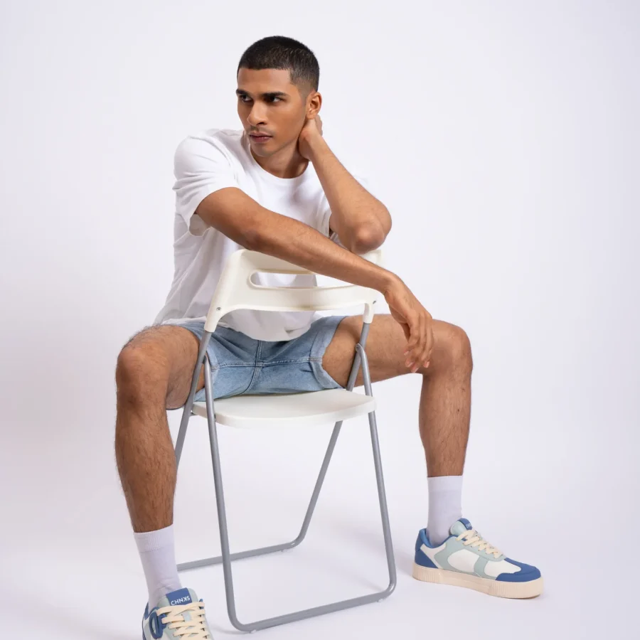 Man wearing Atlantis CHNKS blue sneakers with white t-shirt and blue denim shorts – men’s casual sneaker style