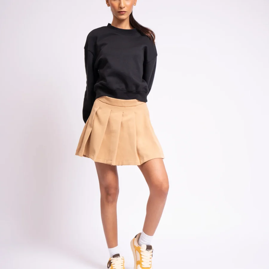 Model wearing Buttercotch CHNKS sneakers with black and brown outfit – women’s yellow street sneakers