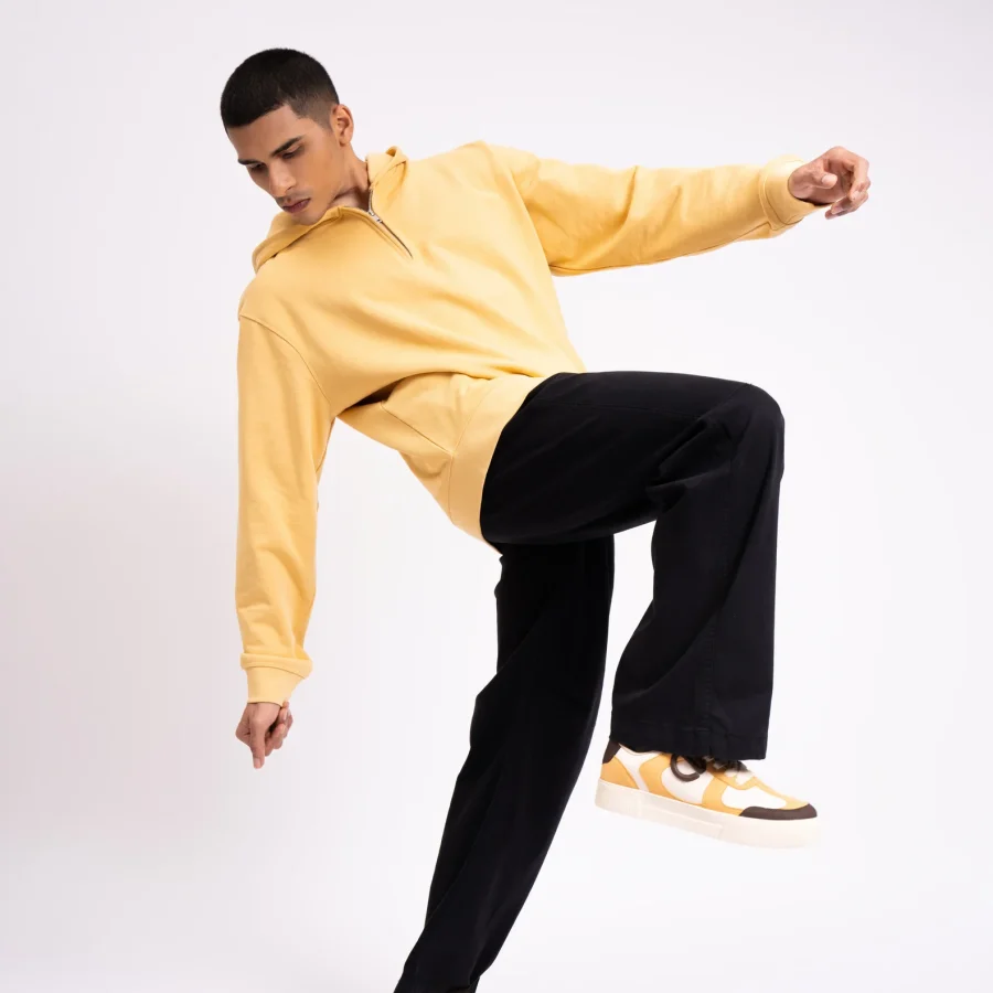 Model wearing Buttercotch CHNKS sneakers with yellow t-shirt and black trouser – men’s yellow sneakers
