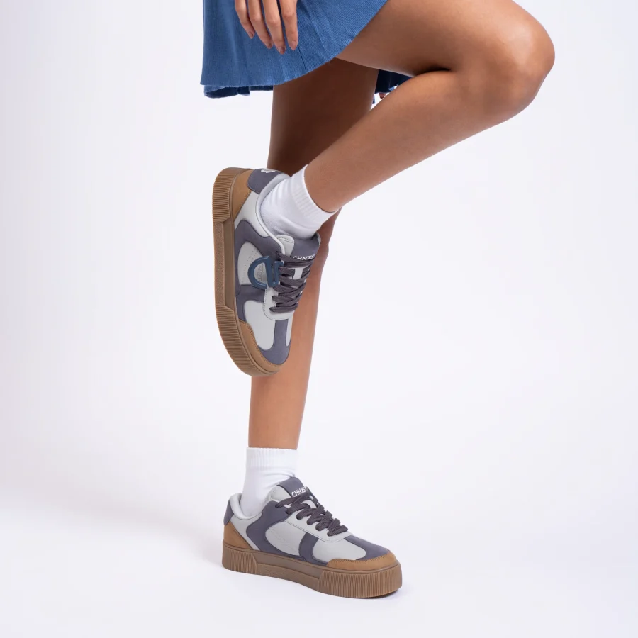 CHNKS grey sneakers paired with a denim dress