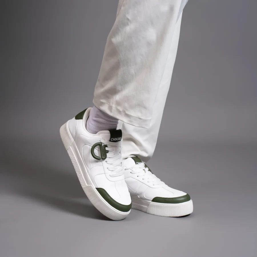 Icy CHNKS sneakers on leg – men’s white sneakers with green accents for daily streetwear